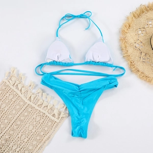 Close-up of sky blue bikini top showing removable padding and adjustable halter neck straps