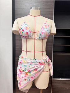 Detail of floral chiffon beach wrap sarong with white lace trim and pink bow decor