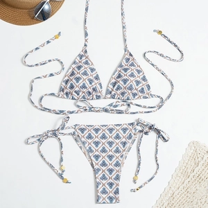 Flat lay of plaid bikini with halter ties and metallic details for beach vacations