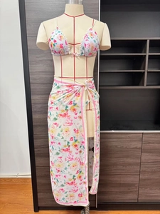 Detailed shot of floral print chiffon sarong with lace trim and matching 3-piece bikini set