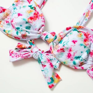 Detailed close-up of floral print bikini top with front knot and adjustable straps