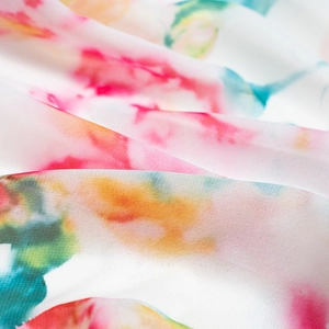 Macro detail of high-quality floral print fabric with vibrant watercolor patterns and texture