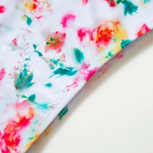 Close-up of floral butterfly print on white fabric with professional double-stitched seams