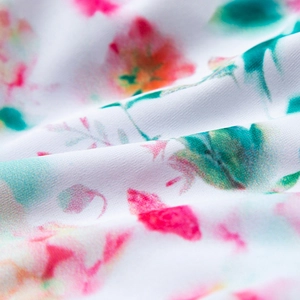 Detailed macro view of soft floral print fabric with pink and green patterns