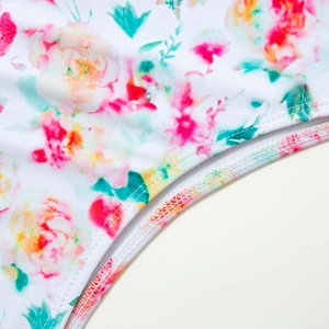 Detail view of the high-quality digital floral print and precise double stitching on the swimsuit