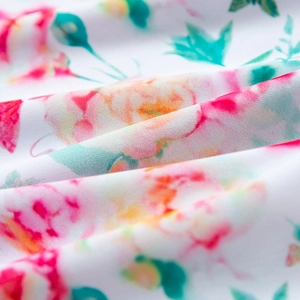 Close-up of floral print fabric with pink roses and green leaves on white base