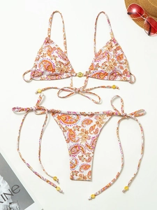 Paisley print bikini set with halter top and tie-side bottoms on white background