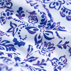 Detailed macro view of bohemian floral print fabric and clean edge stitching on bikini