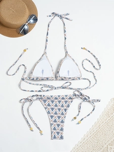 Lace-up plaid bikini set with halter top and tassel ties on white beach background