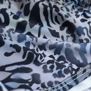 Close-up of blue leopard print bikini fabric with high-quality double-needle stitching