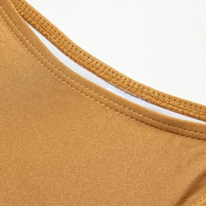 Detailed close-up of golden shimmer nylon fabric with precise double-needle stitching