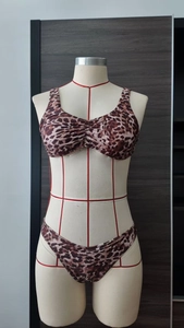 Detail view of leopard print bikini set showing center ruched halter top and matching bottoms