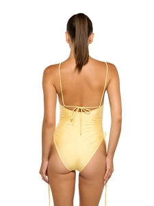 Pale yellow one-piece swimsuit with cross-back tie straps and high-cut leg opening
