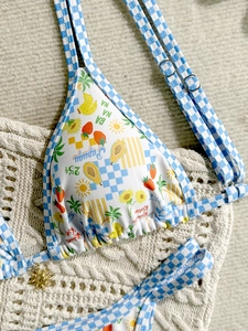 Women's sexy bikini set with fruit patterns and blue plaid straps on beige crochet