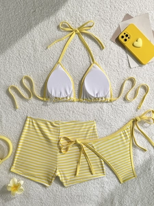 Three-piece yellow striped bikini set with halter top and boy-leg shorts