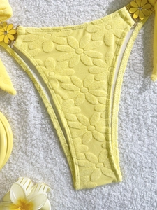 Chic lemon yellow textured floral bikini bottom with side ties and metal flower hardware