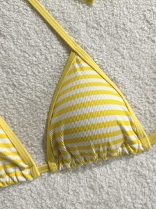 Striped yellow and white ribbed bikini top with halter neck and textured fabric