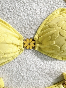 Solid yellow floral textured bikini top with daisy jacquard fabric and center flower buckle