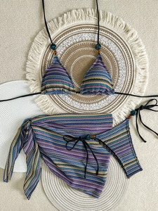 Detailed macro view of colorful striped knit bikini set with decorative beads