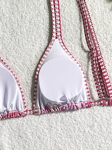 Three-piece bikini top detail showing removable pads and red-white checkered pattern