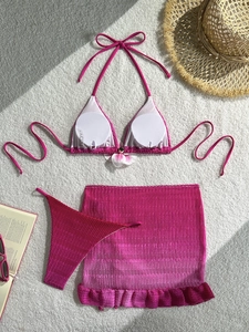 Three-piece pink gradient bikini set with floral detail and mesh skirt for beach vacation