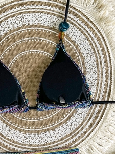 Three-piece bohemian crochet bikini set with halter top and colorful knit accents