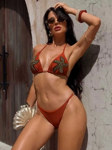 Detail of rust red bikini top with starfish sequin embroidery and halter neck design