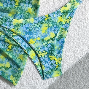 Detailed view of floral pattern bikini bottom with smooth fabric on soft white texture
