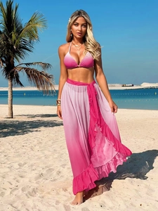 Detailed view of pink gradient bikini top and ruffled beach skirt for resort wear
