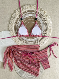Detailed flat lay of rose pink knit halter bikini set with beaded straps and cover-up