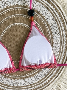 Detail of bikini top showing white inner lining and removable padded cup insert