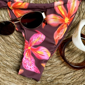 Close-up of high-cut floral bikini bottoms featuring vibrant tropical hibiscus print
