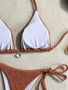 Detail of caramel textured bikini fabric featuring wave patterns and soft inner padding