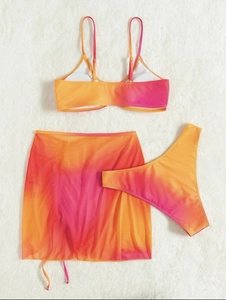 Detailed flat lay of three-piece gradient bikini set with matching mesh drawstring skirt