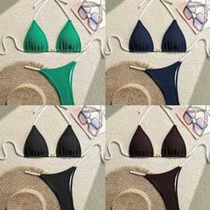 Detailed flat lay of bikini sets in four colors with beach accessories and metal buckles