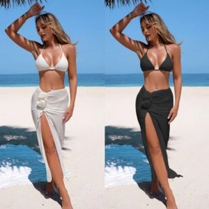 Detailed close-up of beach skirt with 3D flower applique and sexy high side slit design