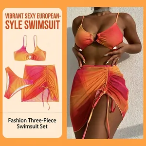 Three-piece bikini set with gradient orange-pink hue, metal rings and mesh sarong cover-up