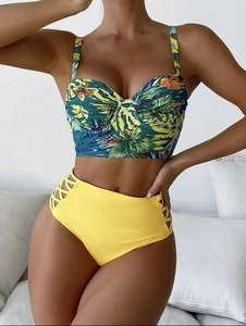 Detail of high waisted yellow bikini bottom with side cut-out crisscross strappy details