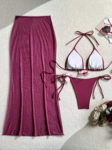 Three-piece burgundy bikini set with 3D floral accents and sheer mesh maxi skirt