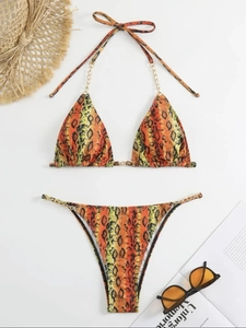 Sexy snake print bikini set with gold chain straps and thong bottom on white background