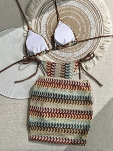 Three-piece crochet bikini set with halter top, bottom, and matching skirt in wave patterns