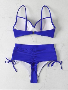 Detail showing deep blue bikini top back straps with metal buckles and high waist bottom