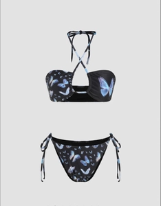 Detail of black bikini set featuring vibrant blue butterfly print and side-tie bottoms