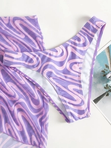 Flat lay of purple and pink wave print bikini set with matching mesh cover-up