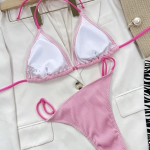 Hot pink ribbed bikini set with halter top and high-cut bottom on white background