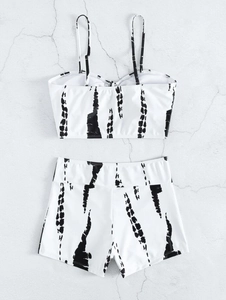 Women's two-piece bikini set with black tie-dye print on white fabric top and shorts