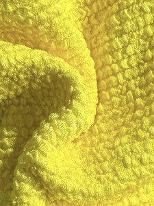 Macro view of high-absorbent yellow microfiber fabric texture for swimwear lining