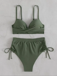 Close-up of olive green high-waisted bikini with side drawstring and ruched cross-front top
