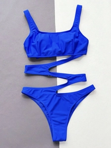 Close-up of electric blue cut-out swimsuit with a metallic ring waist connector