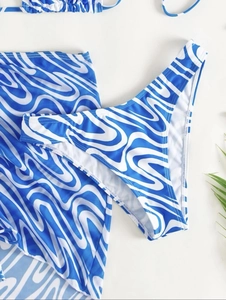 Three-piece bikini set with blue marble print, high-slit bottoms and matching sarong skirt